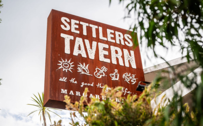 Settlers_Tavern_Food_OBJ887488 Sign for Settlers Tavern with icons and the phrase "all the good things in life," surrounded by trees. Located in Margaret River.